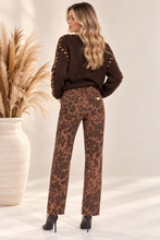 Jeans animalier con bottoni dorati